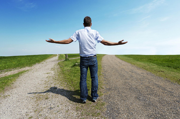 Person standing between two paths symbolizing decision paralysis and procrastination
