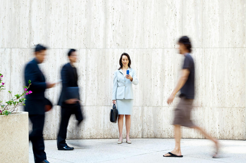 people distracted by phones in public space showing loss of awareness and focus