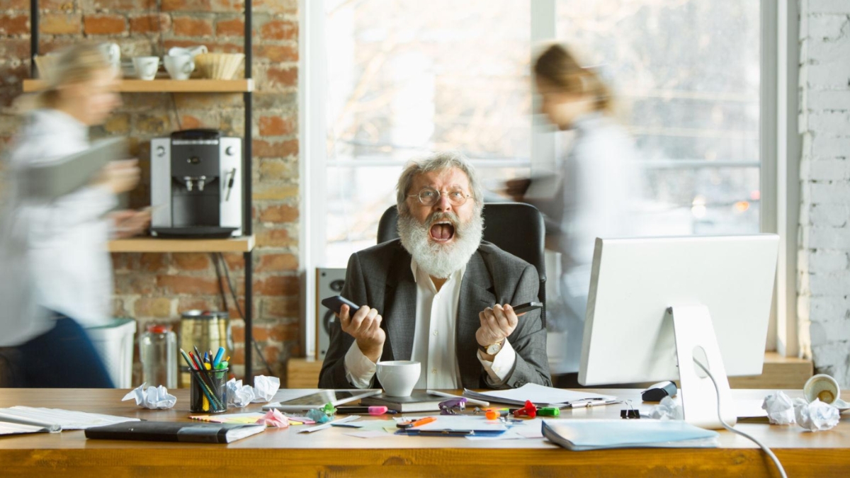 overwhelmed office worker surrounded by distractions losing focus in busy workplace environment