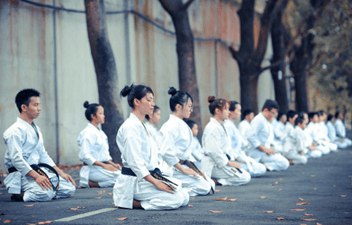 People practicing tai chi to develop emotional awareness calmness and self-control
